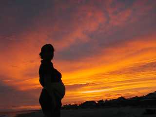 Pregnant six months at sunset